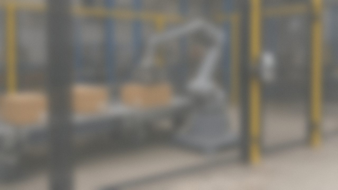 Industrial robot arm working in an automated cell