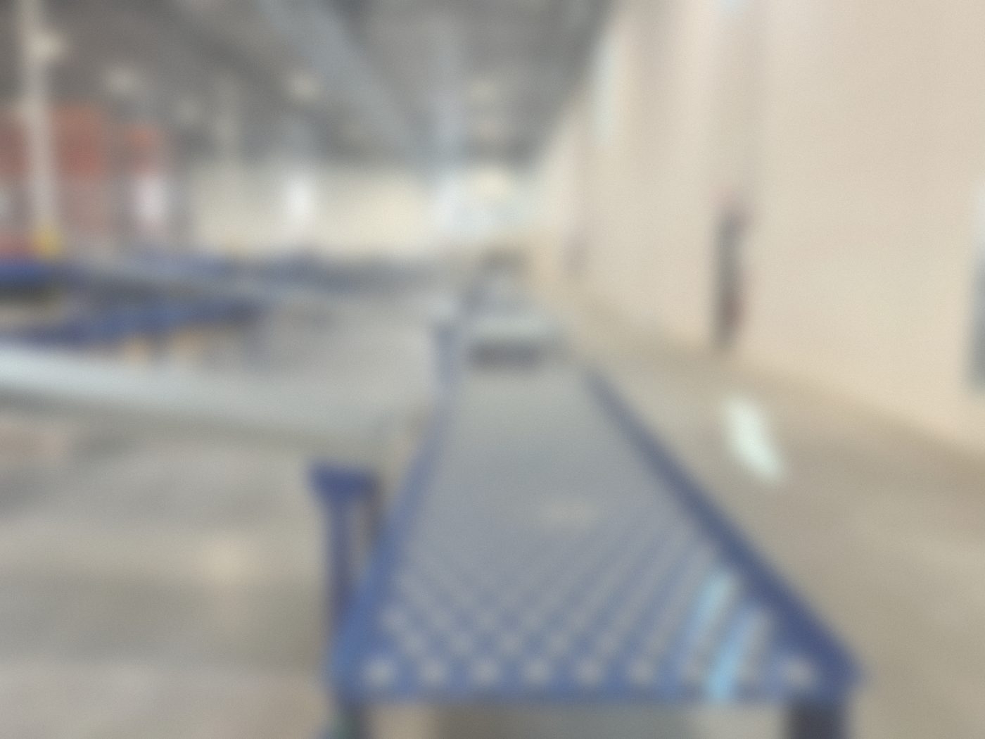 Ball transfer table joined to gravity roller conveyors in a warehouse
